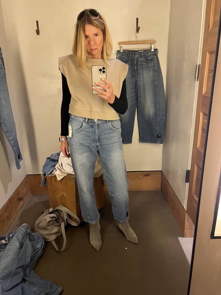 Woman in an Anthropology dressing room trying on Pilro-brand jeans.