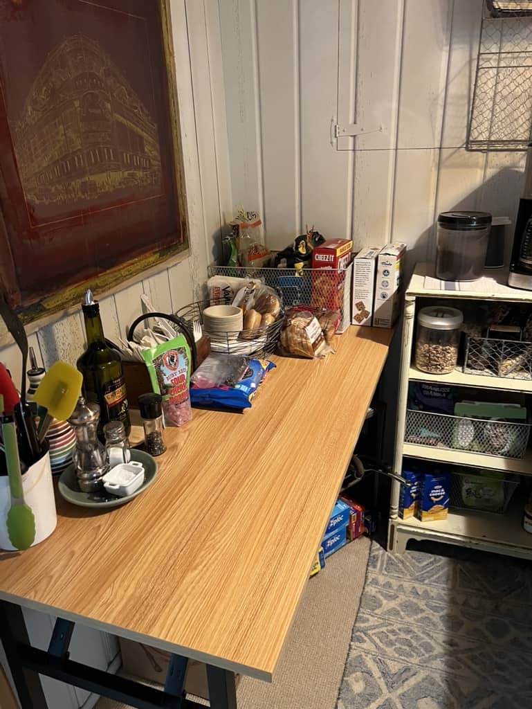 Faux-wood top folding table used in the bar area as a temporary kitchen.