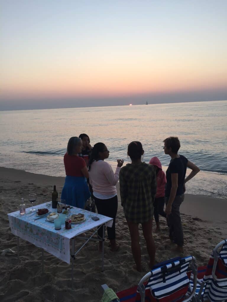 People gathered on the beach at sunset