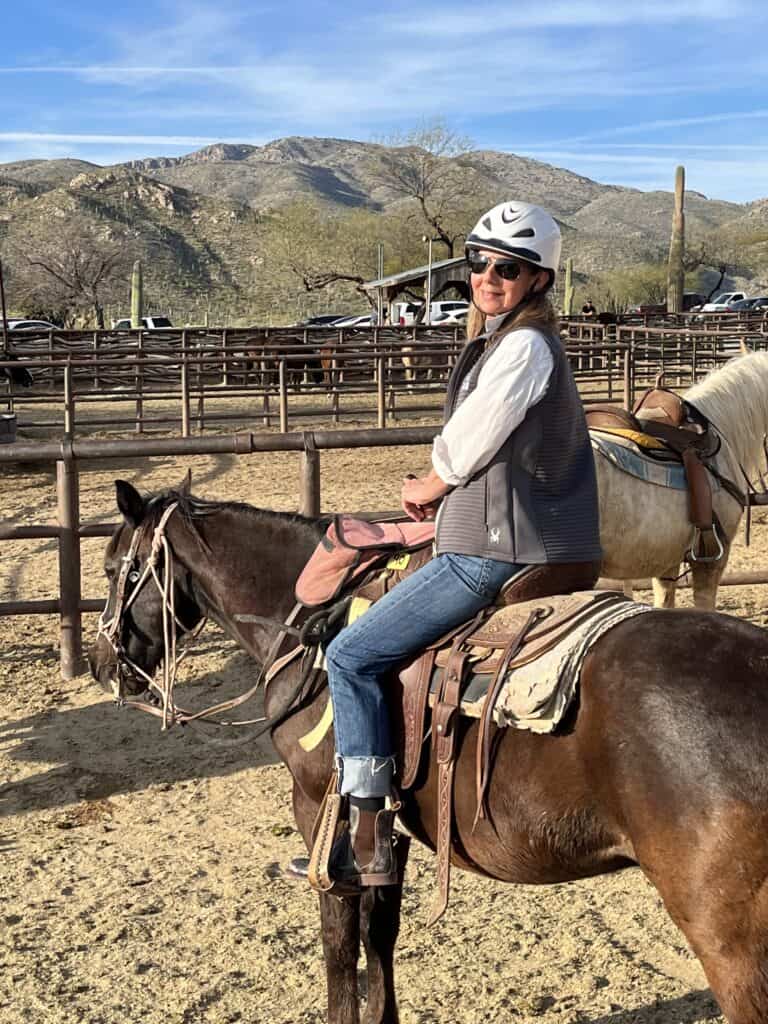 Woman sitting on a horse during the perfect spring break trip.