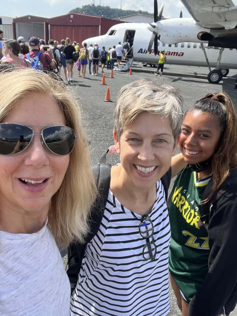 Photo of three people about to board an Air Panama flight. 