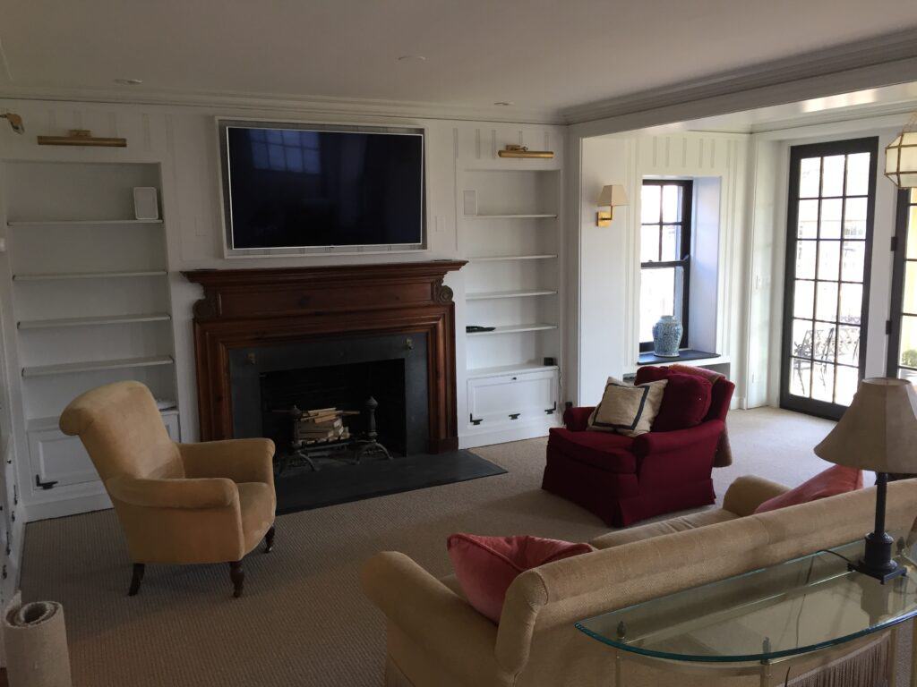 After photo of the painted room with the mounted TV above the fireplace.