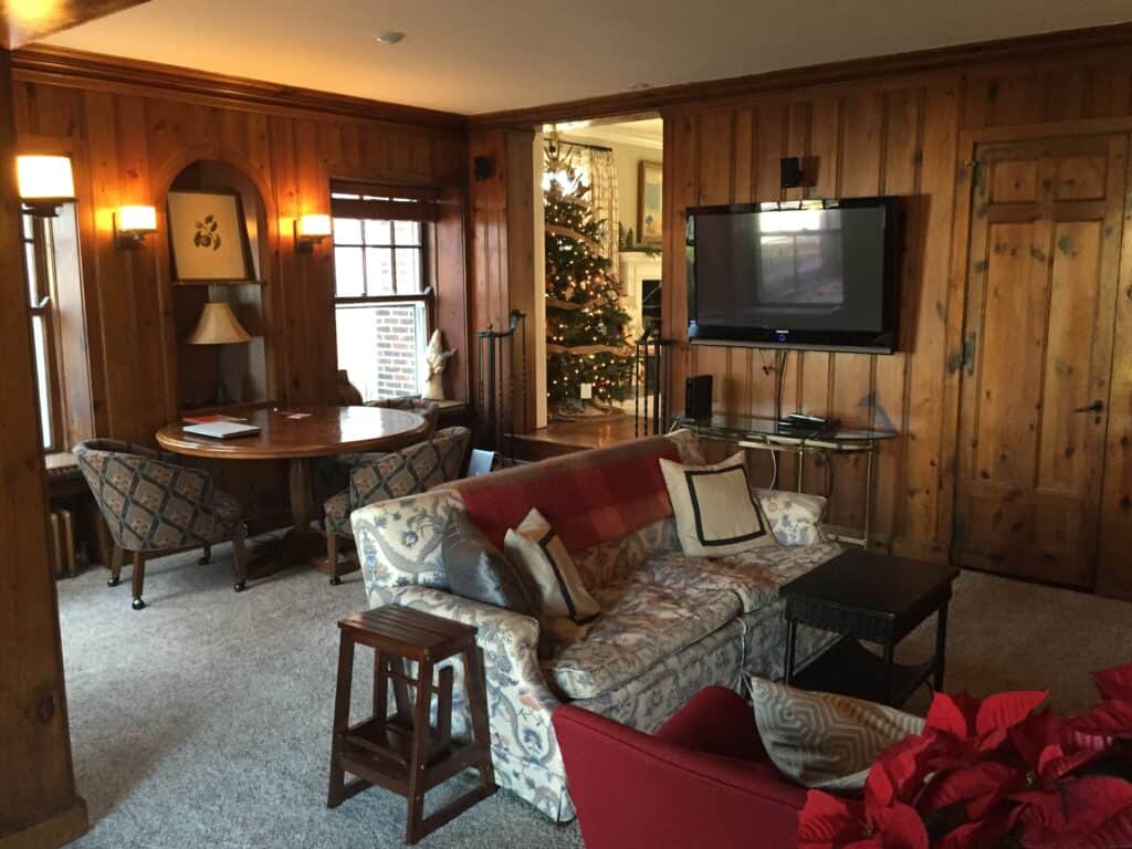 Before picture of a dark and moody paneled family room