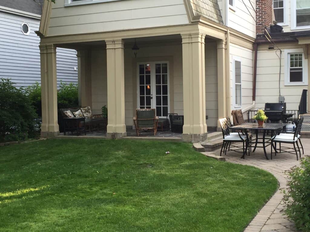 Photo of a covered back porch and French Doors that are part of a 1934 addition.