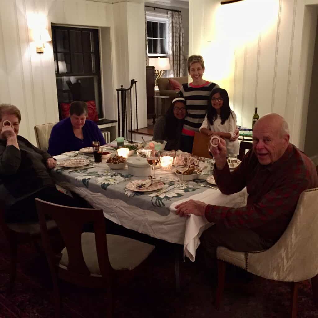 A family sitting down to Thanksgiving dinner in the new, light and open family room. 