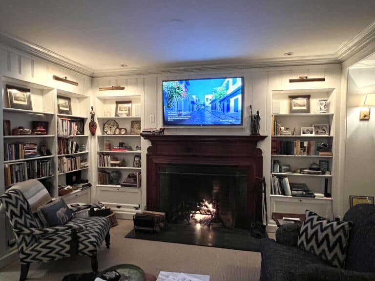 Photo of the family room with the TV placed above the fireplace