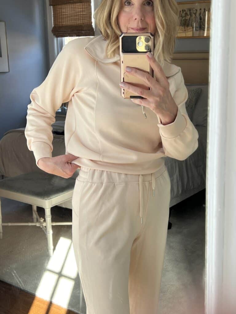 Woman in a cream-colored 2-piece lounge set showing waistband