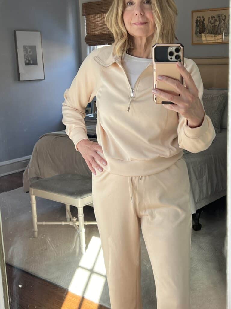 Woman in a cream colored 2-piece lounge set as she tries to improve her loungewear game.