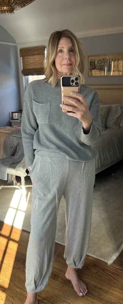 Woman in a two-toned grey matching sweater set trying to improve her loungewear game.
