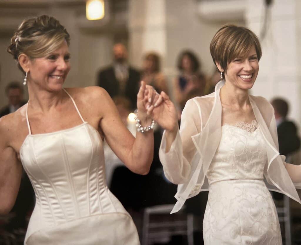 Close up of two woman in wedding dresses, illustrating that the perfect wedding dress for my body type broke all my style rules.