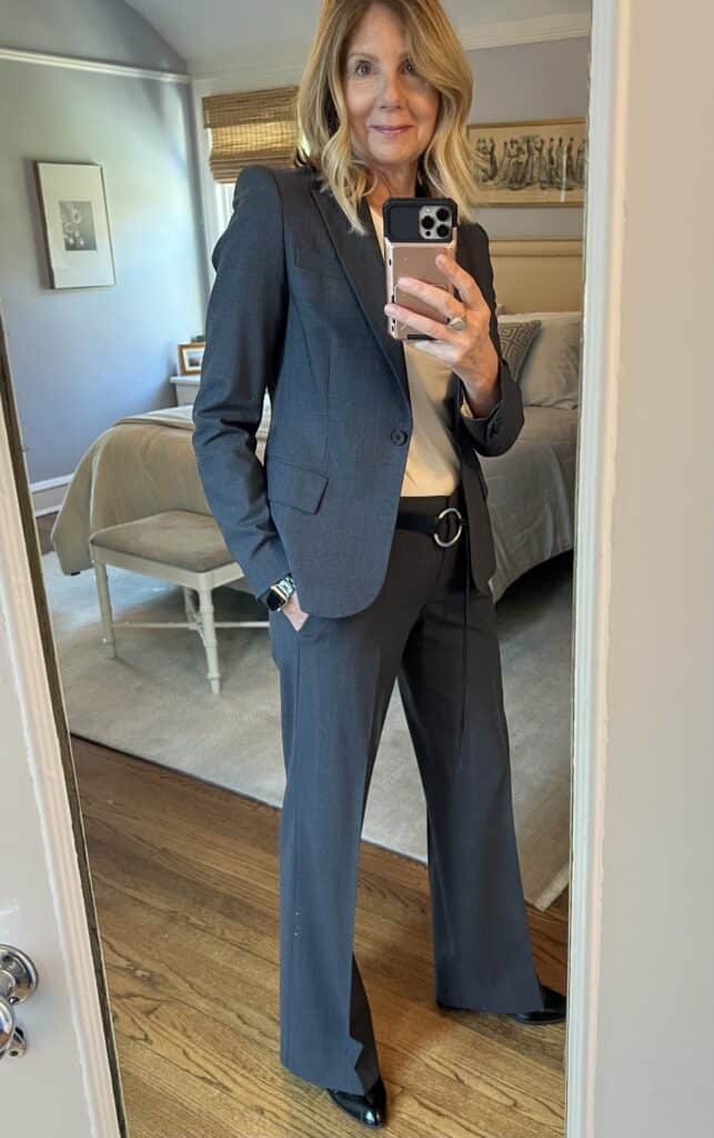Photo of a woman in a grey suit, an example of where to invest to update your wardrobe. 