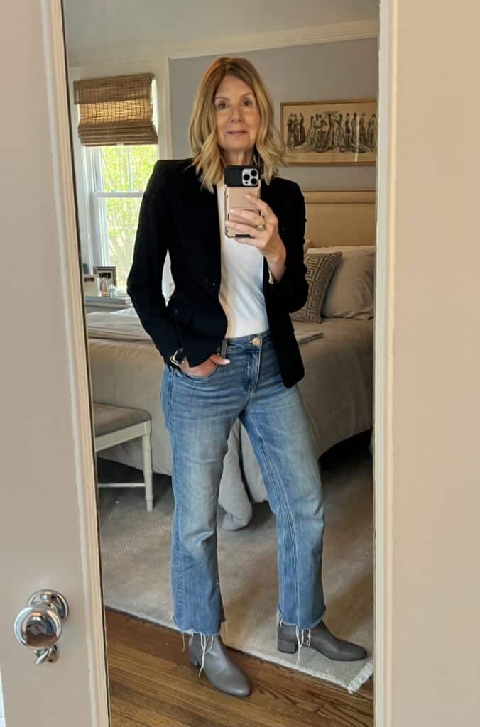 Photo of a woman in the same black blazer and jeans