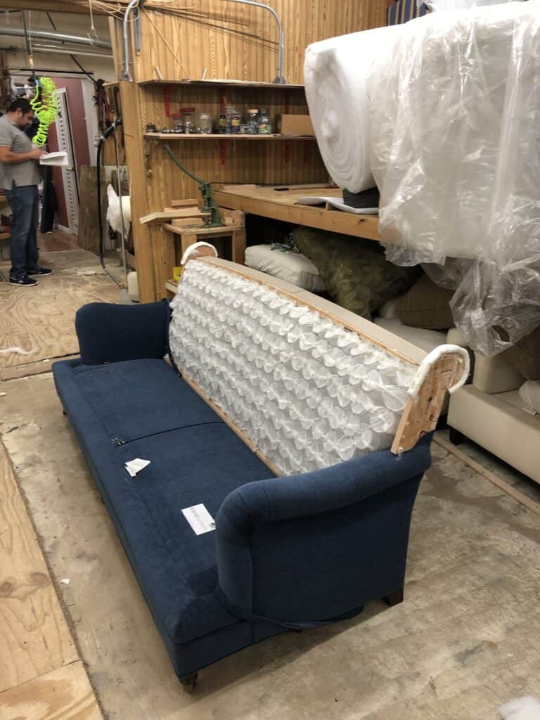 Sofa with the back exposed, ready to be transformed from a roll-back, to a straight-back sofa. 