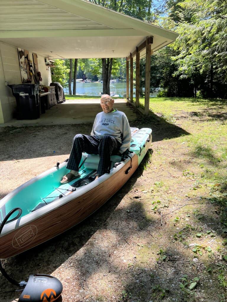 Man sitting in the inflatable BOTE kayak. 