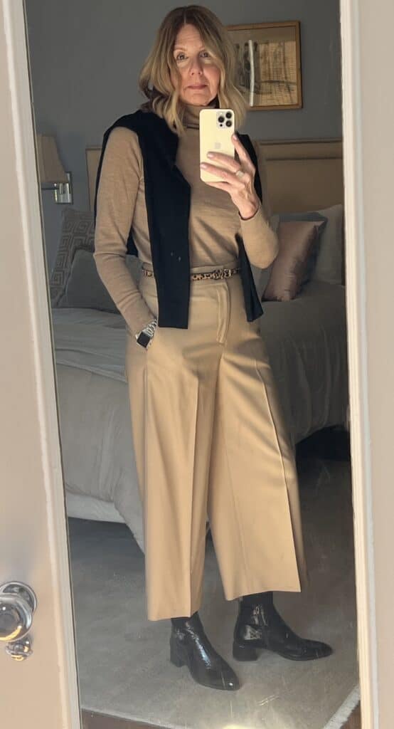 Photo of a woman in beige slacks and sweater. 