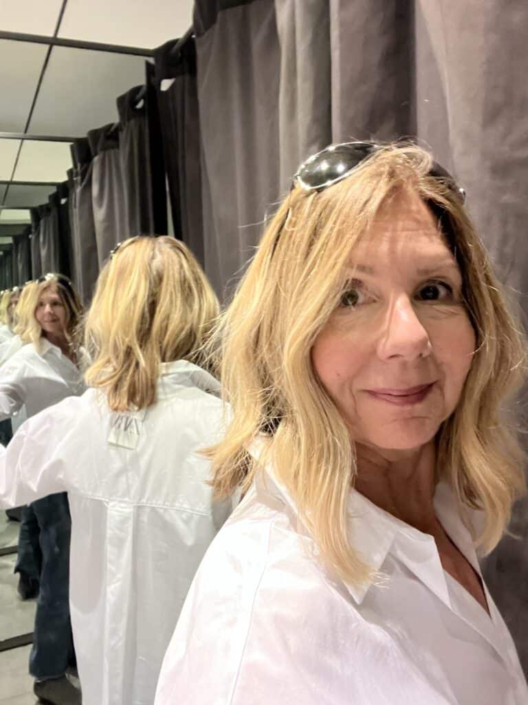 View of the back of the shirt in the mirror of the dressing room. 