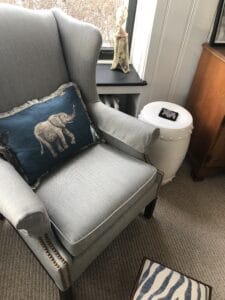 Grey wing chair with the finished elephant pillow. 