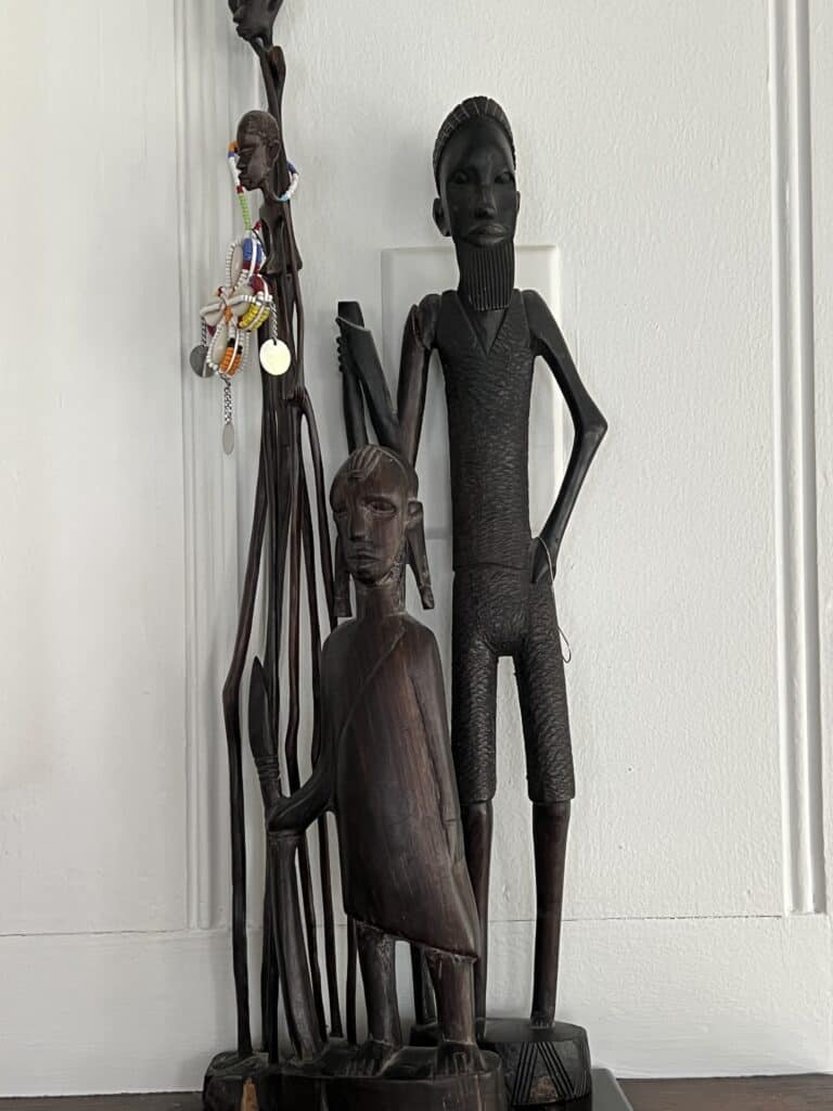 Carved African figures used as accent pieces in Nancy Meyers meets Jane Goodall style. 