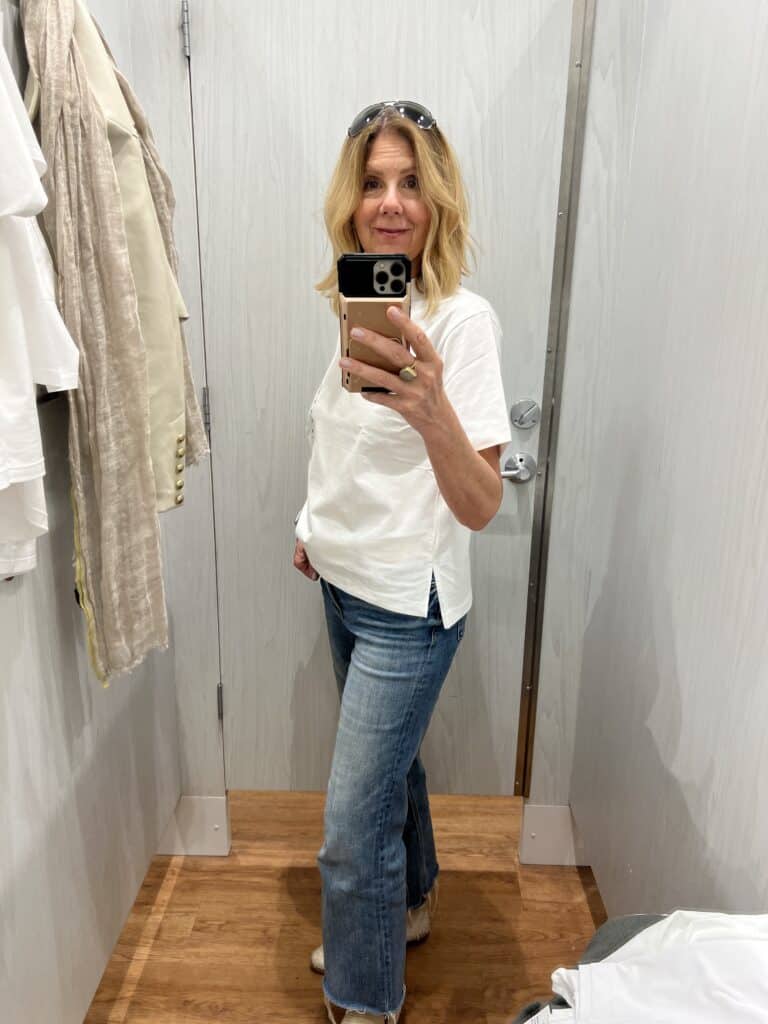 Woman in a white t-shirt from Zara that is slightly longer in the back. 