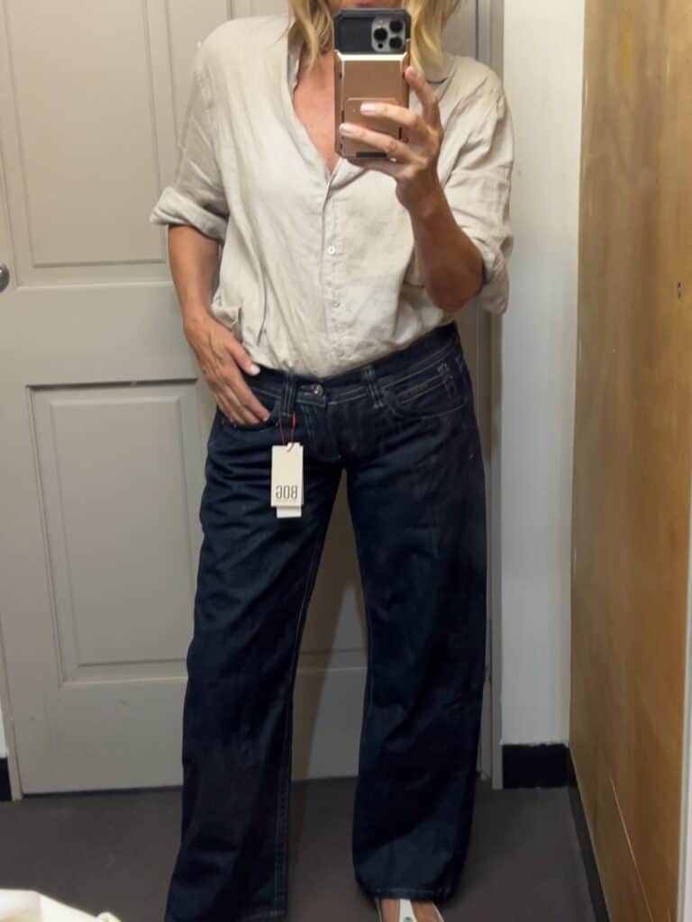 Woman trying on BDG jeans at Urban Outfitters. 