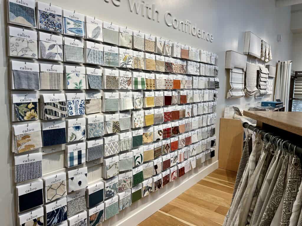 Photo of the swatch wall at Calico, a retail outlet that provides access to designer fabric to use in your interior design