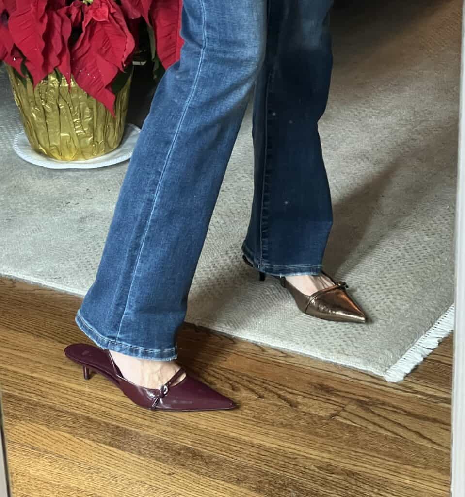 Woman trying on burgundy and gold kitten heel pumps to accompany her affordable holiday outfits. 