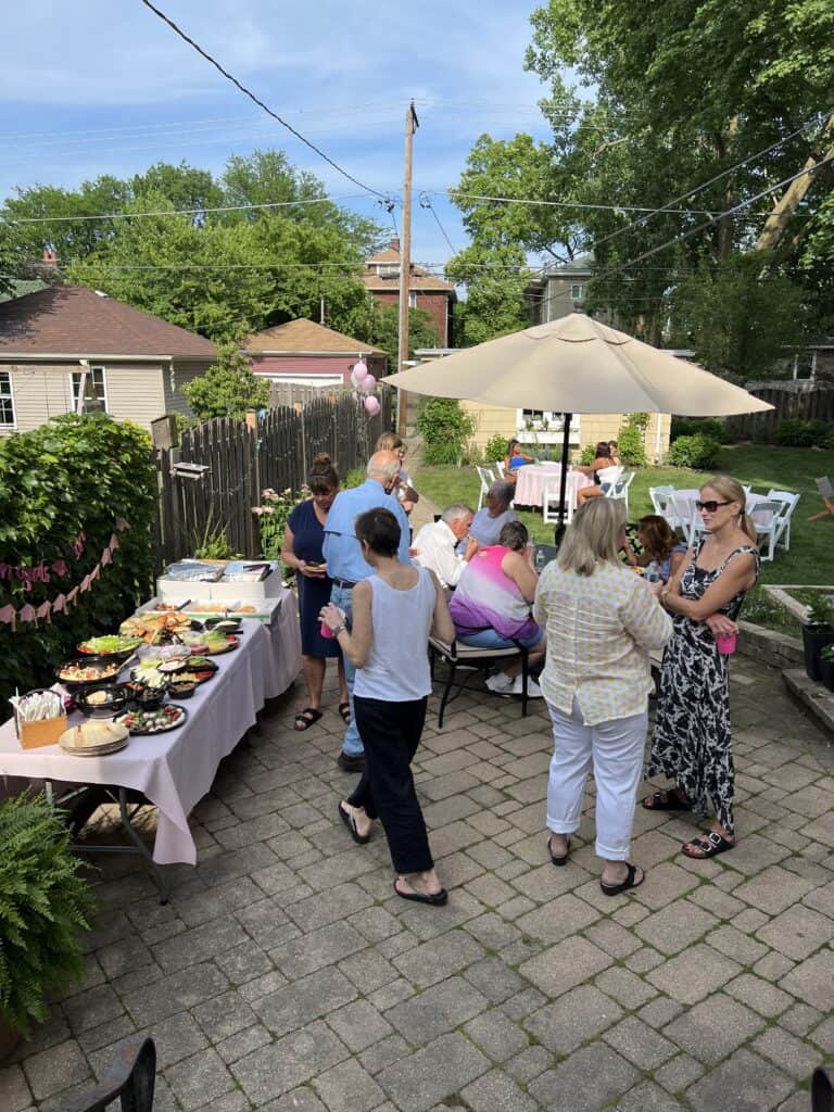 Photo of a graduation party taking place in a backyard.