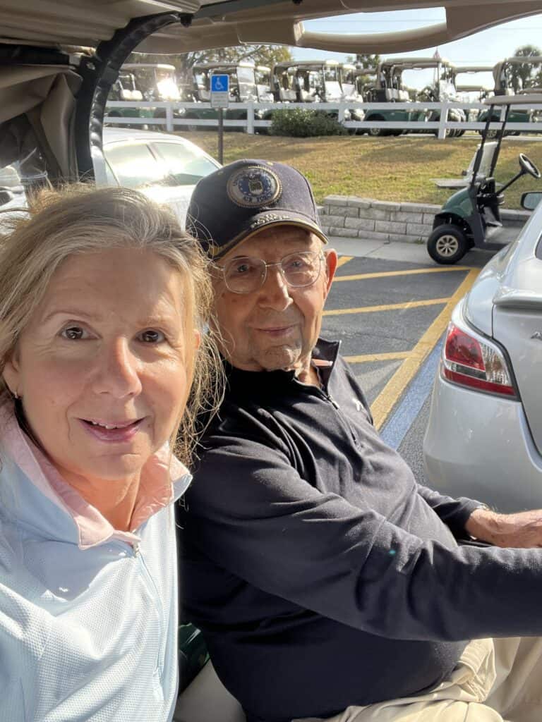 Photo of Dad and I in a golf cart. 