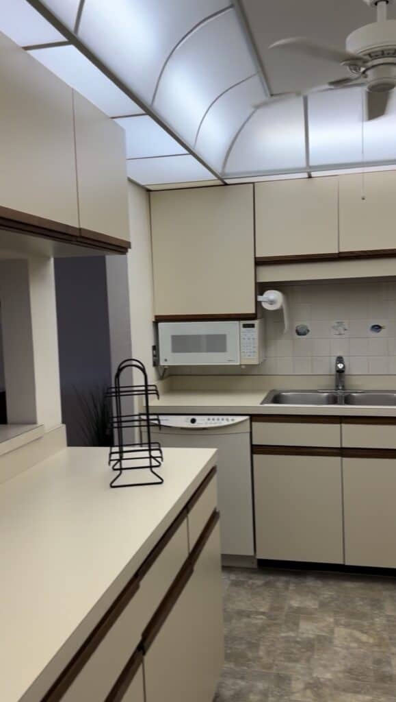 Photo of the left side of the 80's dated kitchen. 
